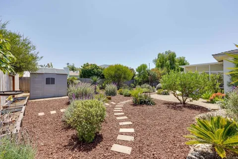 a view of a backyard with sitting area