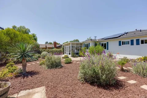 a view of a house with backyard and garden