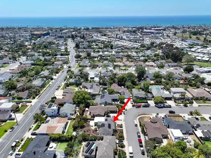 an aerial view of a house with a yard