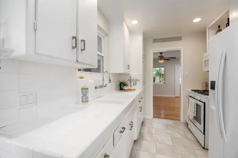 a kitchen with a sink stove and refrigerator
