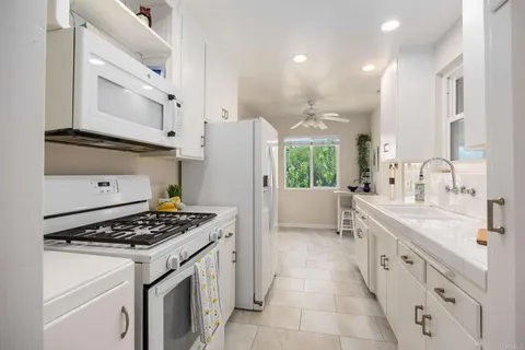 a kitchen with a sink stove and refrigerator