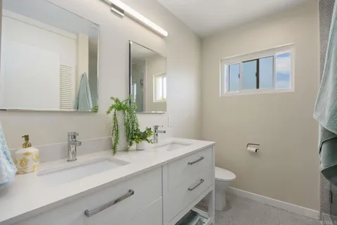 a bathroom with a sink mirror and vanity