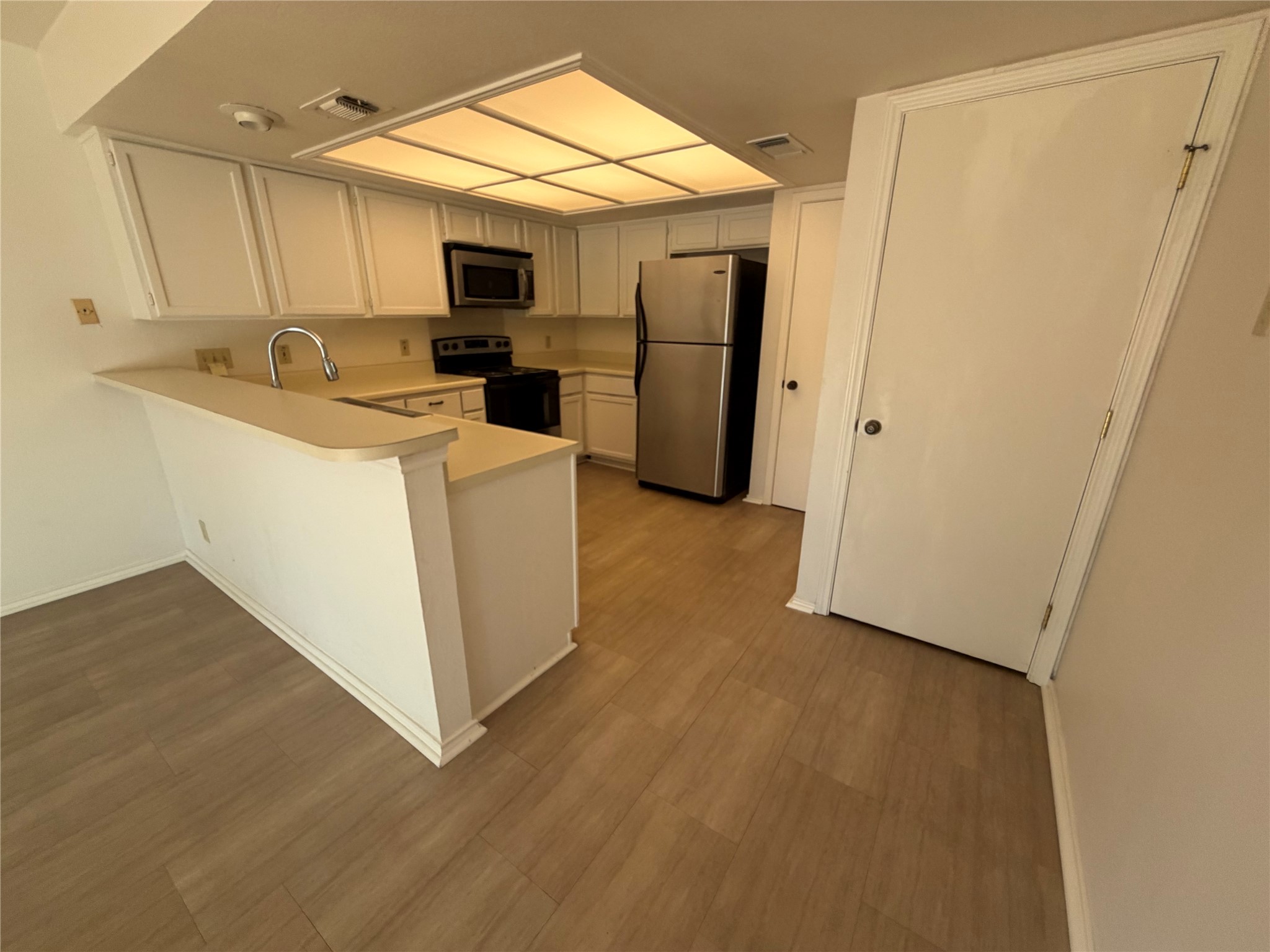 Spacious kitchen ready for an update. Has pantry and a walk-in laundry room to the right.