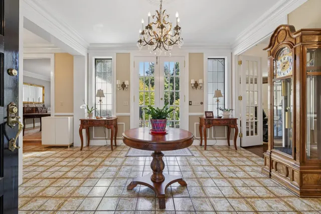 a living room with furniture a flat screen tv and a floor to ceiling window