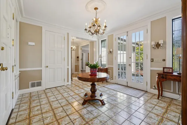 a kitchen with white cabinets and window