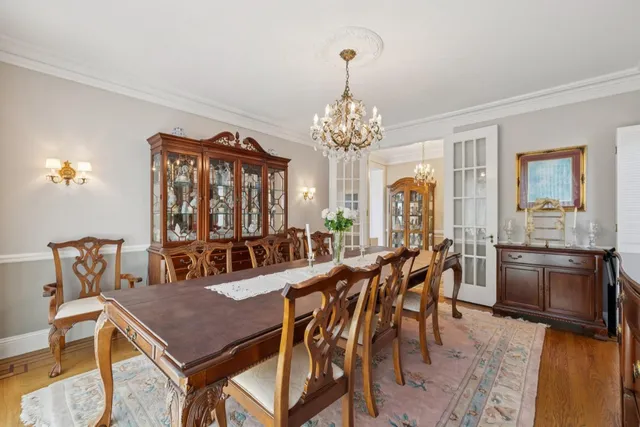 a bedroom with a bed and a computer on a desk next to a window