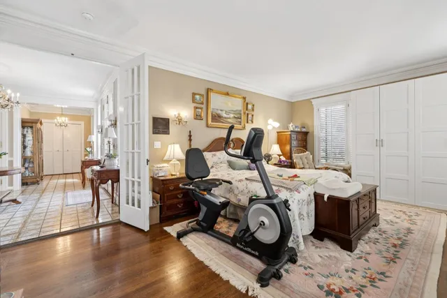 a spacious bedroom with a bed a couch and a dresser