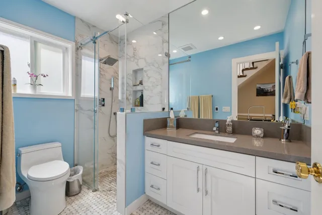 a bathroom with a sink double vanity and a mirror