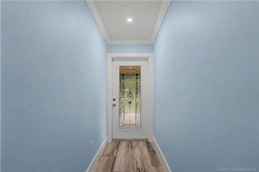8200 Southwest Springhaven Avenue Indiantown, FL 34956 - Photo 15 of 35 a view of a hallway with wooden floor and a window