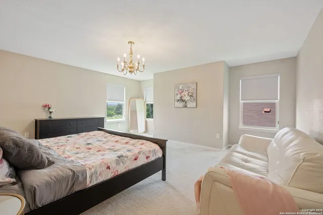 a bedroom with a bed and a chandelier