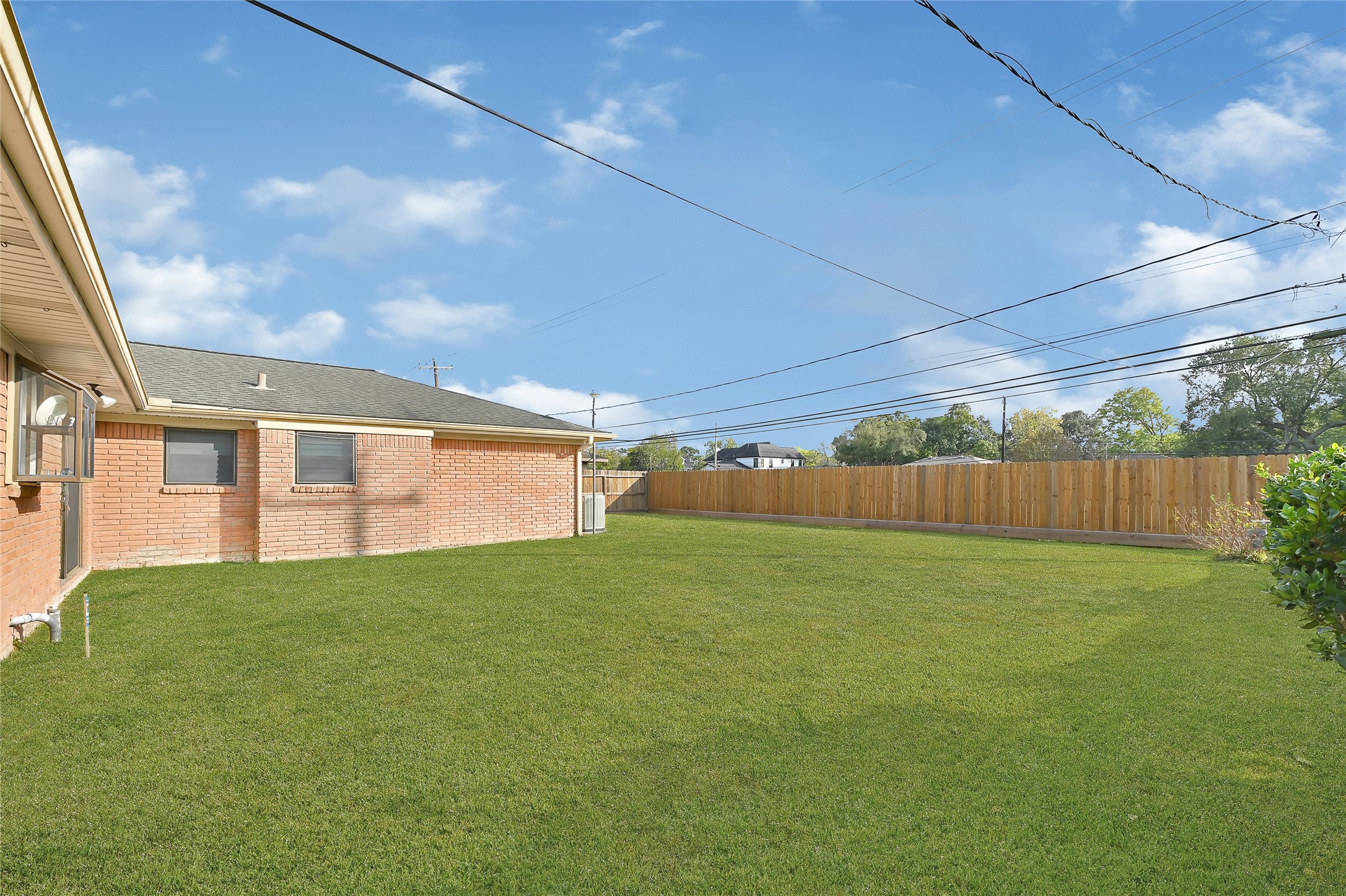 4831 Knickerbocker Street Houston, TX 77035 - Photo 47 of 50 Expansive backyard with a well-maintained lawn, perfect for outdoor activities.