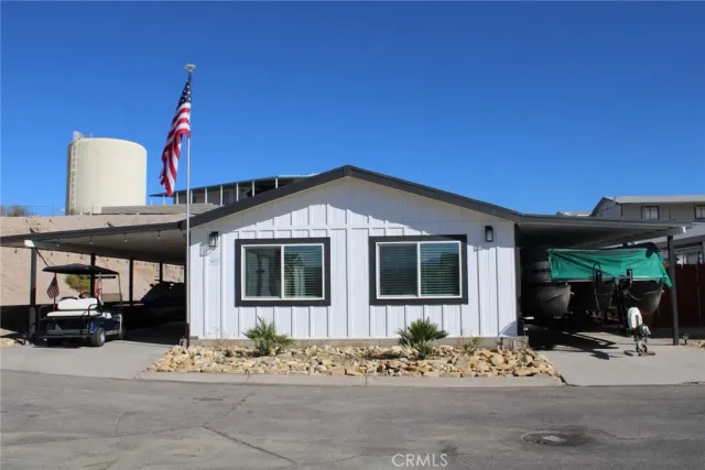 a view of a house with street next to a road