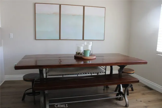 a view of a kitchen area with furniture and wooden floor