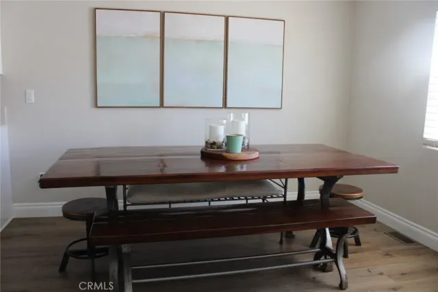 a view of a kitchen area with furniture and wooden floor