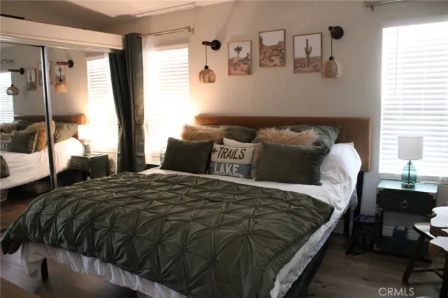 a bedroom with a bed and wooden floor