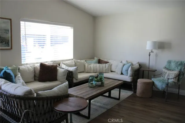 a living room with furniture a window and a table