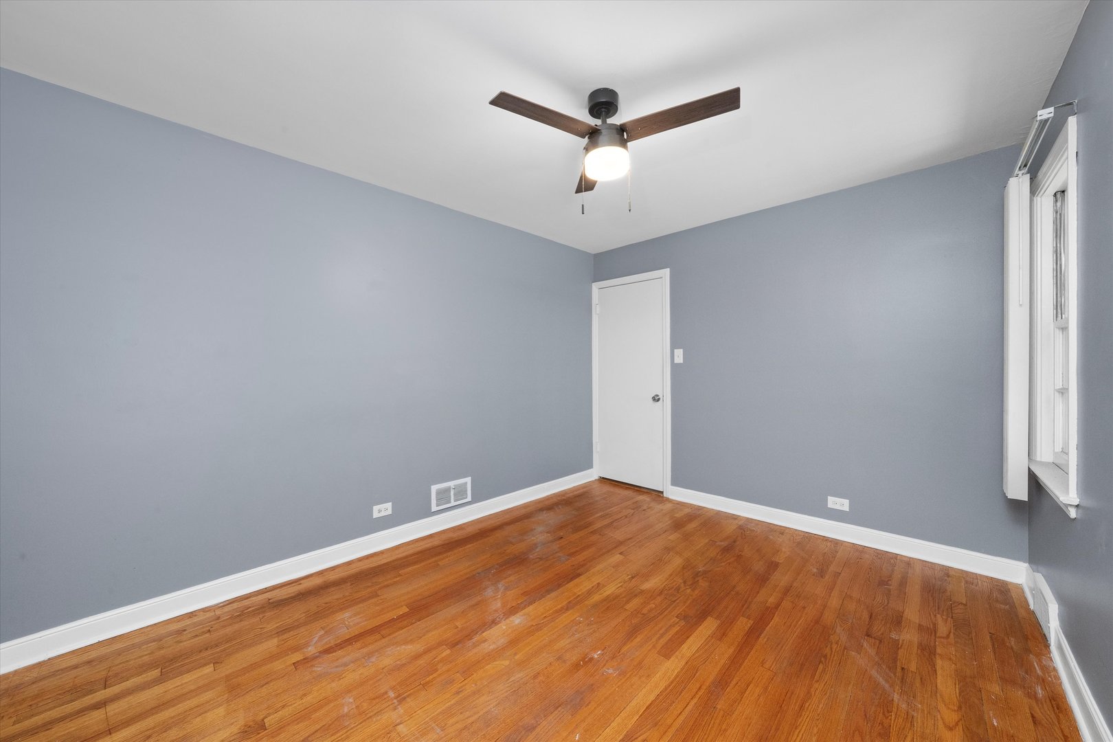 3905 West 81st Place Chicago, IL 60652 - Photo 15 of 32 a view of a big room with wooden floor and windows