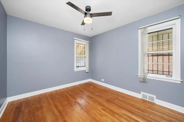 a view of a room with a window and wooden floor