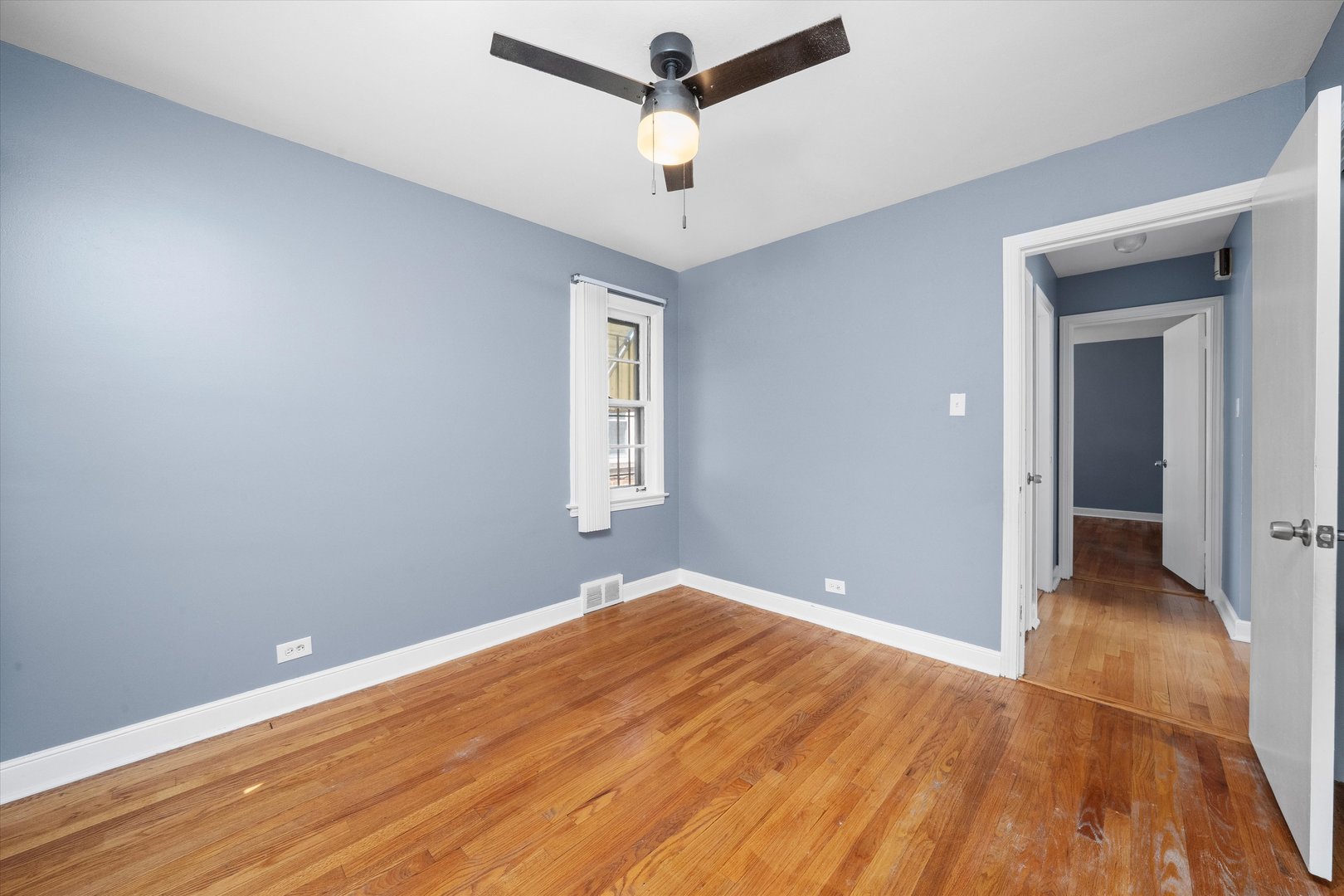 3905 West 81st Place Chicago, IL 60652 - Photo 17 of 32 a view of empty room with wooden floor and ceiling fan
