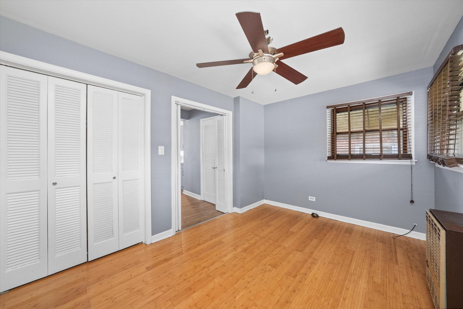 3905 West 81st Place Chicago, IL 60652 - Photo 19 of 32 a bedroom with a large bed and a chandelier fan