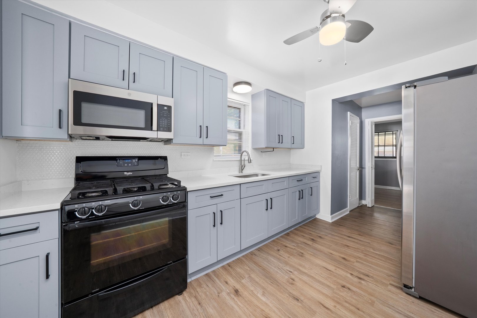 3905 West 81st Place Chicago, IL 60652 - Photo 9 of 32 a kitchen with stainless steel appliances a stove a sink and cabinets