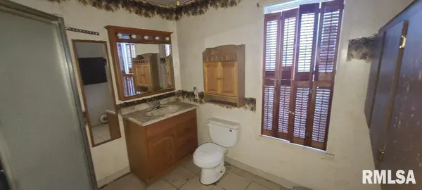 a bathroom with a toilet sink and shower