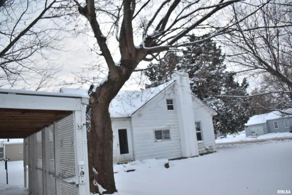 a view of white house with a large tree