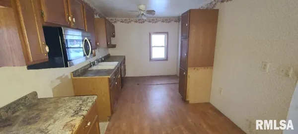 a view of a kitchen from a hallway