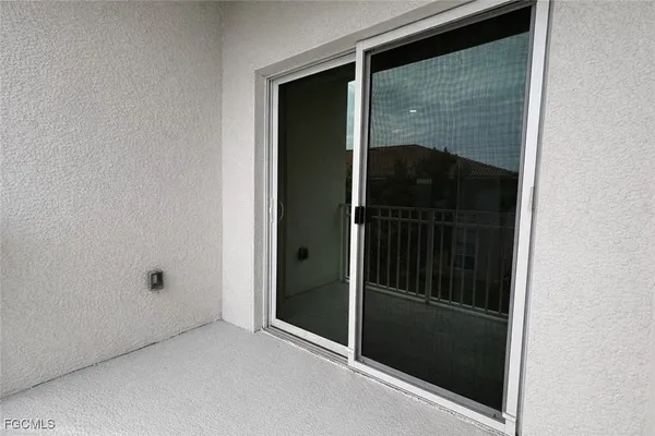 a front view of a house with a yard and potted plants