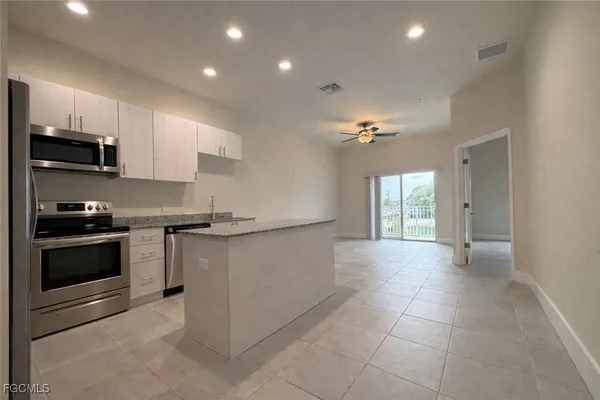 a kitchen with a stove and a refrigerator
