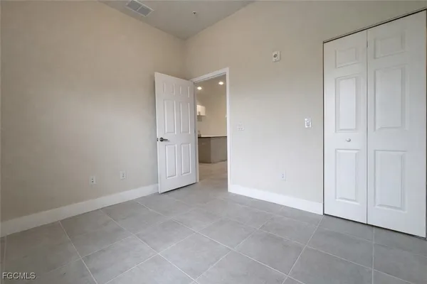 a view of an empty room and closet area