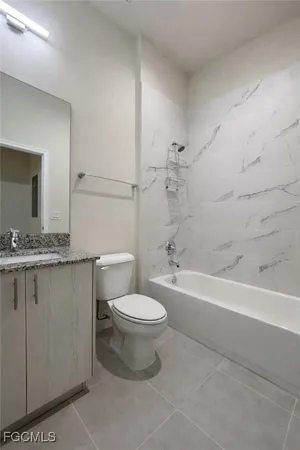 a bathroom with a sink a toilet and a bathtub