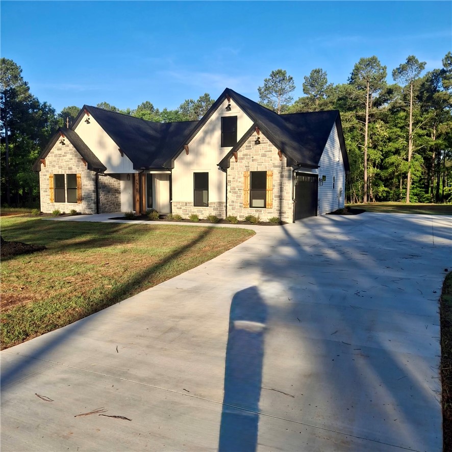 4554 Flat Rock Road Iva, SC 29655 - Photo 3 of 32 A newly built residence with a spacious driveway and surrounding mature trees awaits.