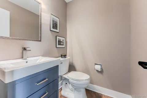 a bathroom with a toilet a sink and mirror