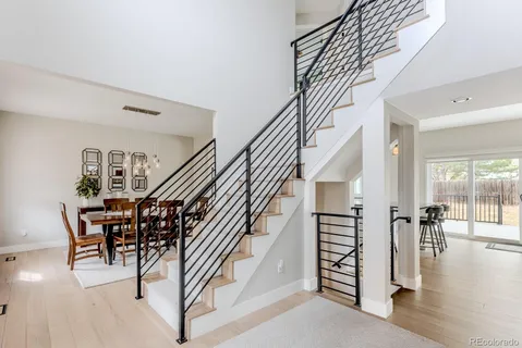 a view of entryway and hall with wooden floor