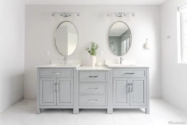 a bathroom with a sink double vanity and a mirror