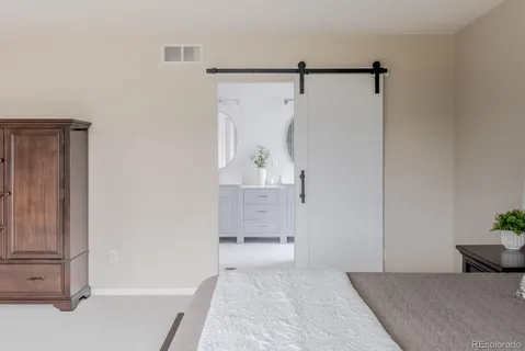 a bedroom with a bed and a shower