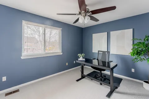 a view of a workspace with a window and a chandelier