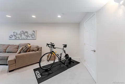 a living room with furniture a flat screen tv and a window