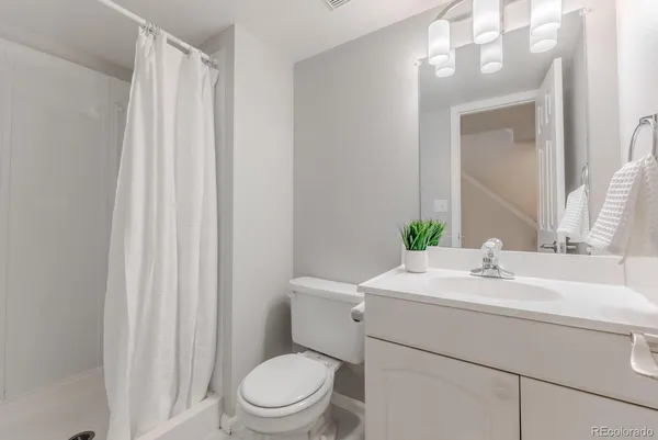 a bathroom with a sink toilet and a mirror