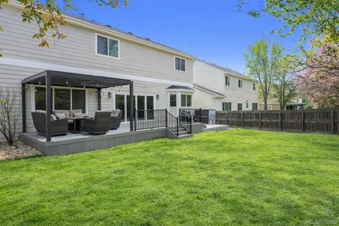 a view of a house with a backyard porch and sitting area