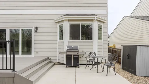 a view of a patio with table and chairs and wooden floor