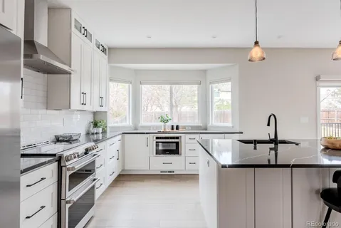 a kitchen with a sink stove and cabinets
