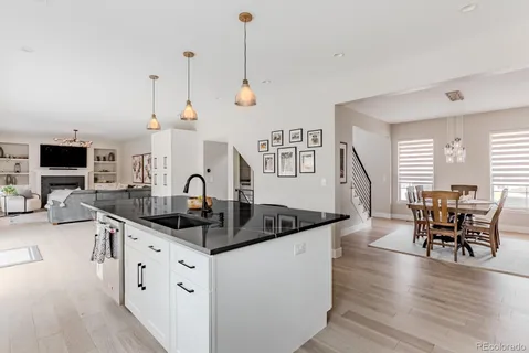 a kitchen with granite countertop a sink and a stove