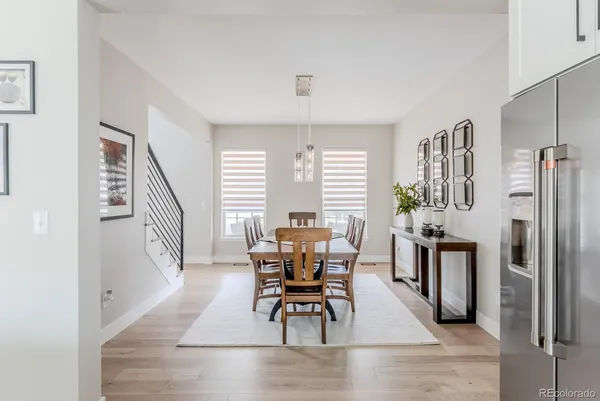 a living room with furniture wooden floor and a large window