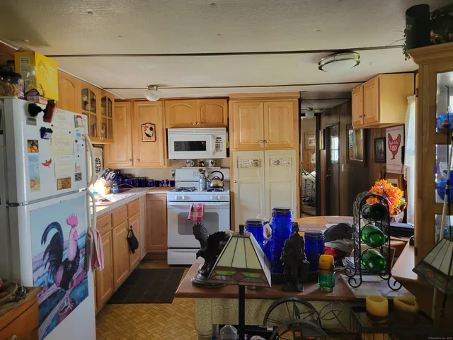 a kitchen with stainless steel appliances granite countertop a refrigerator and a stove