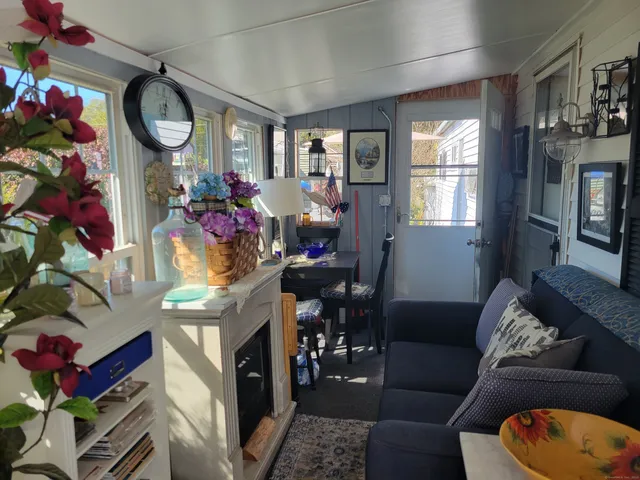 a living room with furniture a chandelier and a fireplace