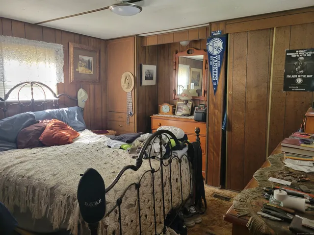 a bedroom with a bed and a mirror