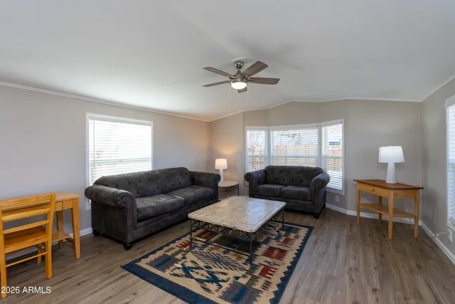a living room with furniture and wooden floor