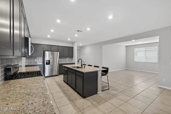 a kitchen with stainless steel appliances granite countertop a stove and a refrigerator